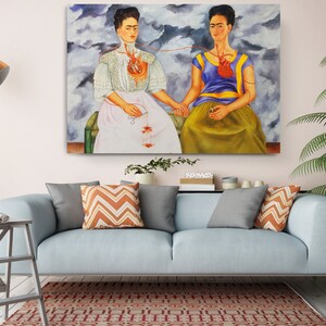 a living room with a couch and a painting on the wall