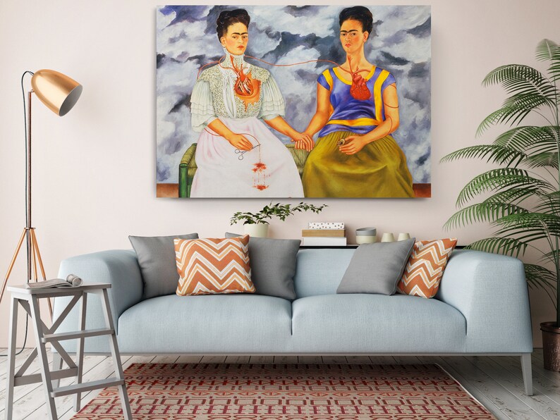 a living room with a couch and a painting on the wall
