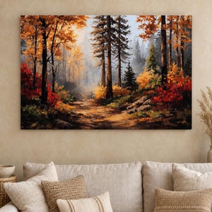 May include: A rectangular wall art print depicting a forest scene during autumn. The landscape features tall dark tree trunks, a dirt path leading into the distance, and foliage in vibrant shades of orange, yellow, and deep red under a hazy sky.