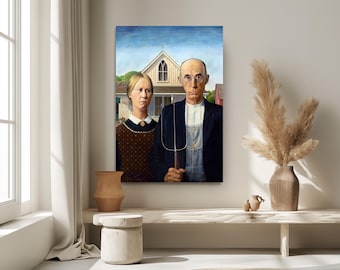 May include: A framed print of Grant Wood's American Gothic painting, featuring a woman in a brown patterned dress and a man in a black jacket and overalls holding a pitchfork, standing before a white house with a pointed gothic window.
