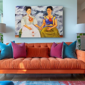 a living room with a couch and a painting on the wall