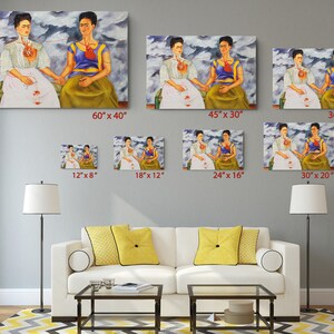 a living room filled with furniture and paintings on the wall