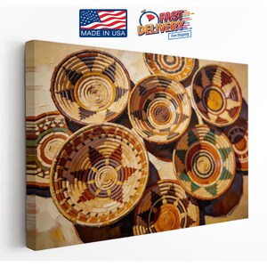 May include: A rectangular canvas wall art print featuring a high-angle view of multiple woven baskets arranged in a cluster. The baskets display intricate geometric patterns in shades of brown, tan, yellow, and green, creating a textured appearance.