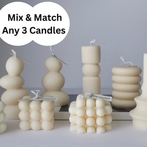 May include: Assortment of 10 unique, cream-colored candles in various shapes and textures.  Mix & Match Any 3 Candles.