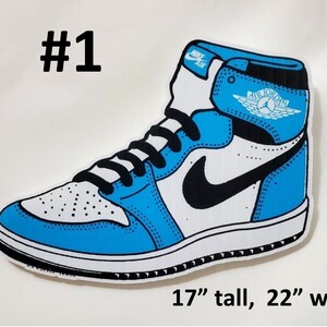 May include: A blue and white Air Jordan 1 sneaker with a black swoosh and a white wing logo. The sneaker is 17 inches tall and 22 inches wide.