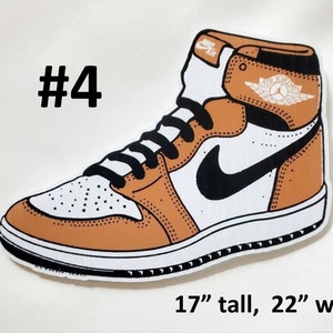 May include: A brown and white sneaker with a black swoosh and the text "Air Jordan" on the side. The sneaker is 17 inches tall and 22 inches wide.