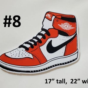May include: A red and white Air Jordan sneaker with a black swoosh and a red and white Air Jordan logo. The sticker is 17 inches tall and 22 inches wide.