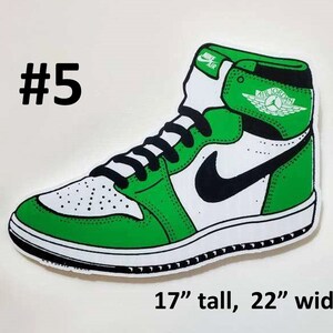 May include: Green and white Air Jordan sneaker with a black swoosh and the text "Air Jordan" on the side. The sneaker is 17 inches tall and 22 inches wide.