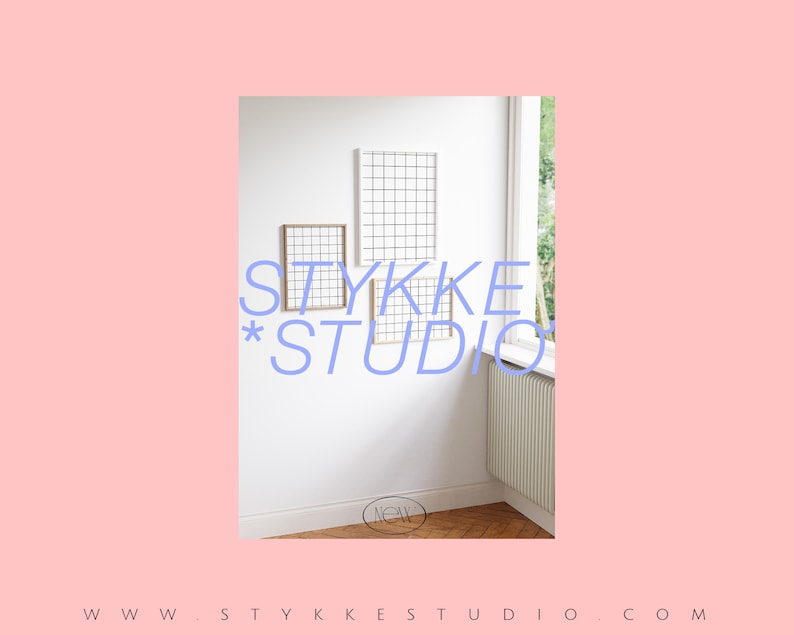 May include: A white wall with three framed grid-like designs. The text "STYKKE*STUDIO" is written in blue letters on the wall. The text "NOW" is written in a circle on the floor.