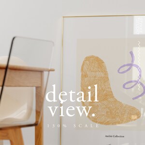 May include: A gold framed print with a beige background and a large abstract shape in the center. The shape is filled with a pattern of thin, gold lines. A smaller, purple shape is in the upper right corner. The text "detail view." is in the lower left corner, and the text "130% SCALE" is below it. The text "Atelier Collection" is in the lower right corner.