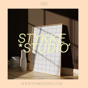 May include: A white and black grid pattern on a framed canvas with a gold frame. The canvas is leaning against a brown wall with a light source shining on it. The text "STYKKE STUDIO" is in yellow letters on the wall. The text "WWW.STYKKE STUDIO.COM" is at the bottom of the image.