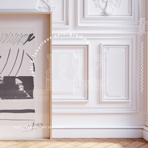 May include: A framed black and white abstract art print with the text "soft & luxurious colorgrading 150% scale detail view" and "illustration is not included" in white text. The print is hanging on a white wall with ornate molding.