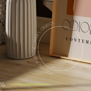 May include: A framed print with the text "Colorgram Contemporary" in black lettering on a light pink background. The frame is made of natural wood.