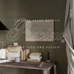 May include: A digital frame mockup featuring a framed illustration of fruit and the text "Preview" in a decorative font. The frame is on a wooden desk with books, a small vase, and a decorative metal mobile.