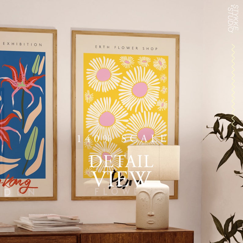 May include: Two framed posters with floral designs. The poster on the left features a red flower with blue and pink accents. The poster on the right features a yellow background with white and pink flowers. The text on the poster on the right reads "Earth Flower Shop".