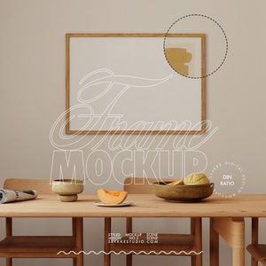May include: A wooden frame mockup with a white background, hanging on a beige wall. A wooden table with a bowl of fruit, a plate with a slice of melon, and a magazine on the table. The text "Frame Mockup" is written in white on the image.