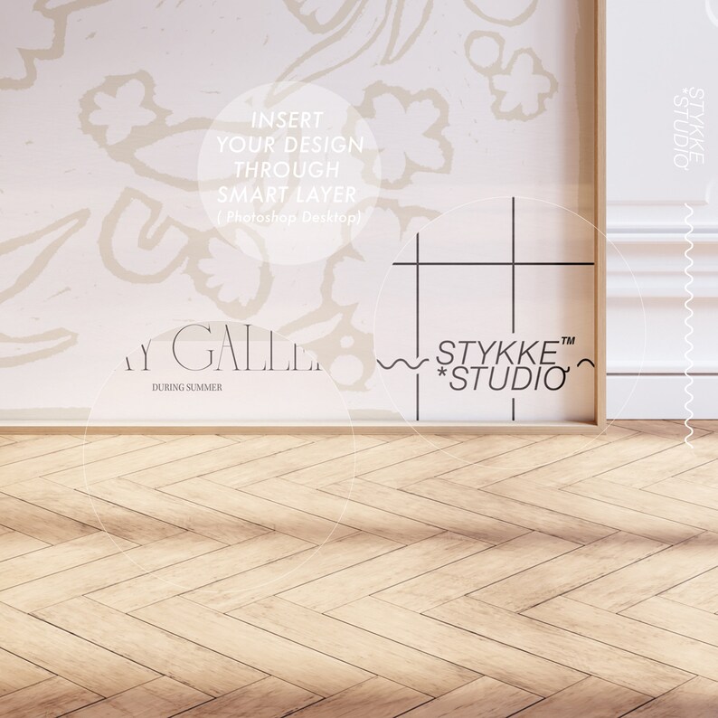 May include: A white wall with a floral pattern and a framed image with a grid pattern and the text "STYKKE&trade; *STUDIO*" and "STYKKE STUDIO". The wall is next to a wooden floor with a herringbone pattern.