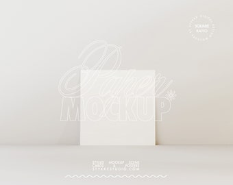 May include: A white square paper mockup on a white background. The text "Paper Mockup" is written in a stylized font above the paper.