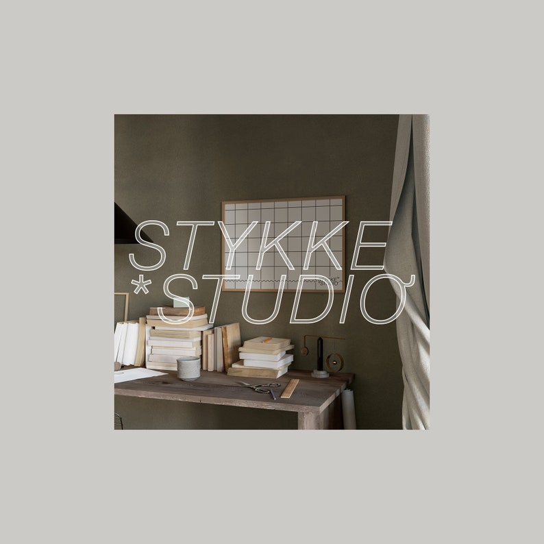 May include: A close-up of a desk with a stack of books, a white gridded board, and the text "STYKKE STUDIO" in white lettering. The desk is made of wood and has a light brown finish. The background is a light brown wall.