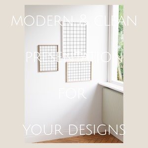 May include: A white wall with three wooden picture frames. The frames are empty and have a grid pattern. The text "MODERN & CLEAN PRESENTATION FOR YOUR DESIGNS" is written on the wall.