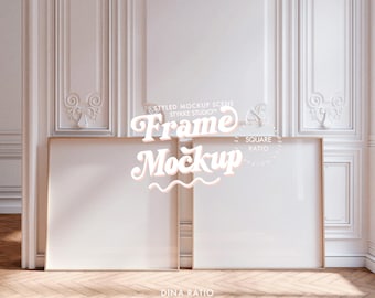 May include: Two square, blank picture frames with gold-colored borders are displayed against a white wall with ornate molding. The frames are positioned on a wooden floor. Text on the image reads "Frame Mockup" and "Human Made High End Mockups for Your Art."