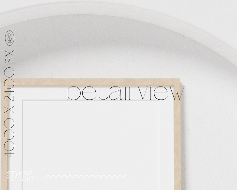 May include: A close-up of a wooden picture frame with a white mat and a white background. The frame is on a white wall. The text "detail view" is visible in the image.