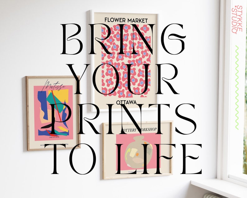 May include: Three framed prints on a white wall. The top print features a pink and blue floral pattern with the text "FLOWER MARKET OTTAWA POTTERY WORKSHOP". The middle print features a colorful abstract design with the text "Metriska THE ARTIST". The bottom print features a pink and beige illustration of a pot with the text "BRING YOUR PRINTS TO LIFE".
