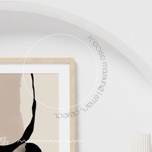 May include: A framed abstract art print with black and beige shapes and a wavy line at the bottom. The print has the text "STYKKE STUDIO" in the bottom left corner.