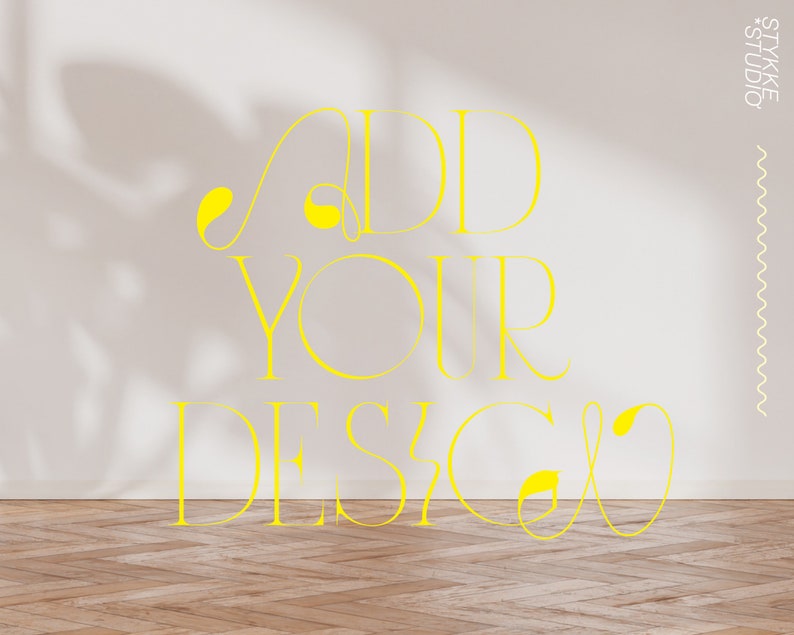 Peut inclure: Un mur blanc avec une ombre de plante dessus. Le texte "ADD YOUR DESIGN" est &eacute;crit en jaune sur le mur.