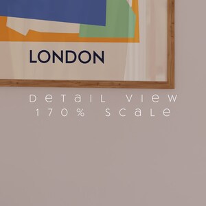 Puede incluir: Un estampado art&iacute;stico enmarcado con un dise&ntilde;o abstracto con formas azules, verdes y naranjas. La palabra "LONDON" est&aacute; impresa en azul marino debajo de la obra de arte. El marco es de madera clara. El texto "DETAIL VIEW 170% SCALE" est&aacute; impreso debajo.