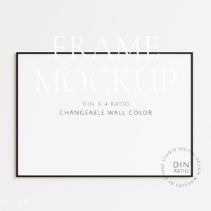 May include: A black frame mockup with the text "FRAME MOCKUP" and "DIN A 4 RATIO" and "CHANGEABLE WALL COLOR" in white text. The frame is on a white wall.