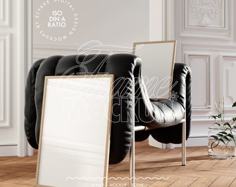 May include: A black leather armchair with a gold frame and a white poster inside. The chair is in a room with white walls and a wooden floor.