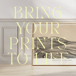 May include: A white wall with a framed print of a black and white abstract design. The print is titled "SORANA DE LA NISP" and is from Berlin, Germany. The text "BRING YOUR PRINTS TO LIFE" is written in yellow letters on the wall.