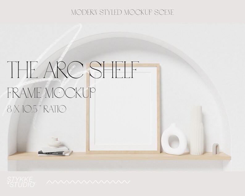 May include: A white wall with a half-circle archway. A wooden shelf with a white frame, a white vase, and a white ceramic object sits inside the archway. The text "THE ARC SHELF FRAME MOCKUP 8 X 10.5" RATIO" is written on the wall.
