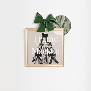 May include: A gold frame mockup with a black and white image of a woman in a dress. The frame is on a white wall with a green bow and a green and white patterned circle.