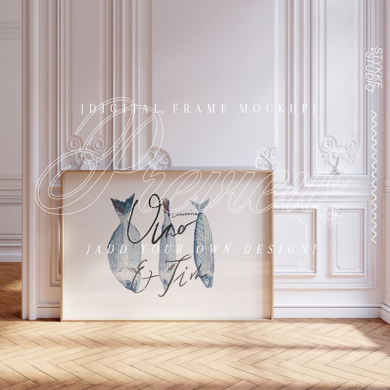 May include: A digital frame mockup with a white background and a gold frame. The frame is displaying a print of three fish with the text "Vino & Fish" in cursive.