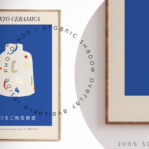 May include: Two framed art prints. The left print features a white vase with colorful abstract shapes on a blue background. Text reads "TOKYO CERAMICS" and Japanese characters. The right print has a blue background with text and Japanese characters.