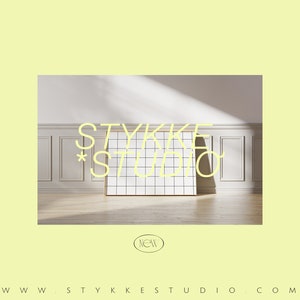 May include: A white room with wood paneling and a white gridded board with the text "STYKKE STUDIO" in yellow. The text "NEW" is in a circle below the board.