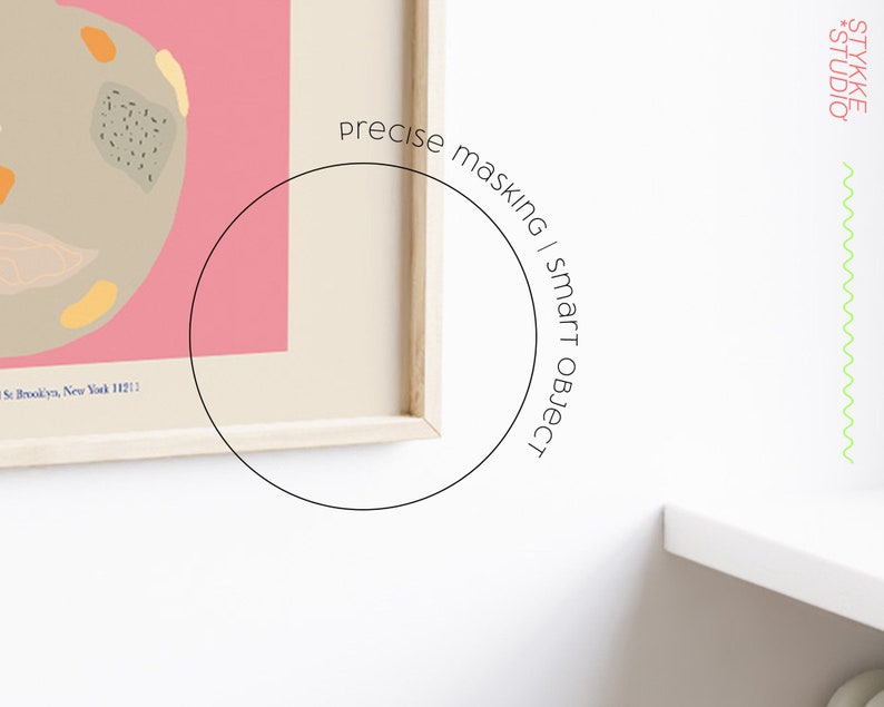 May include: A framed abstract art print with a pink background and a beige shape with colorful accents. The print is in a wooden frame and is hanging on a white wall. The text "precise masking | smart object" is written in a circle around the frame.