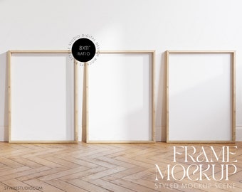 three frames mockup 8:11 ratio, wooden frames mockup on wooden floor in bright room, set of 3 digital vertical frames mock up