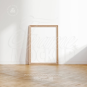 Puede incluir: Una maqueta de marco de madera en una habitación blanca con suelo de madera. El marco está vacío y listo para tu diseño.