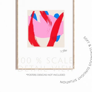 May include: Abstract art print featuring a vibrant composition of red, pink, and blue brushstrokes on a cream background. The print is framed in a light wood frame. Text on the print reads "100% SCALE DETAIL VIEW" and "*POSTERS DESIGNS NOT INCLUDED".