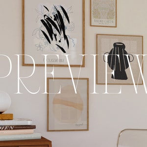 May include: A white wall with a collection of framed art prints. The prints feature abstract designs in black and white, a vase, and a floral motif. The wall is decorated with a white lamp and a stack of books.