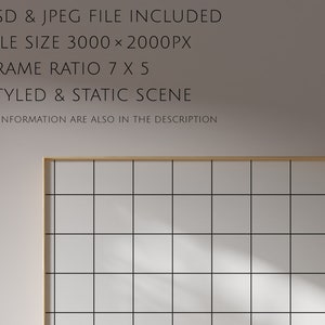 May include: A light grey wall with a wooden frame around a grid of white squares. The frame is casting a shadow on the wall. The text "*STUDIO" and "STYKKE*" is on the right side of the image.