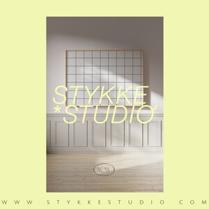May include: A white room with a large window and a gridded picture frame. The text "STYKKE STUDIO" is written in a light yellow font on the wall.