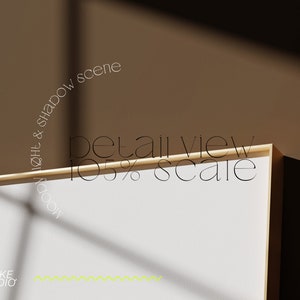 May include: A close-up of a white canvas with a gold frame. The canvas is illuminated by natural light, casting shadows on the surface. The text "detail view 105% scale" is visible on the frame. The text "mood light & shadow scene" is visible in a circular arc above the frame.
