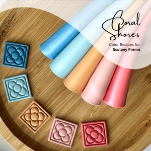 May include: Six polymer clay squares with a flower design in shades of blue, orange, pink, and red. The squares are arranged on a wooden surface. The text "Coral Shores Color Recipes for Sculpey Premo" is visible in the top right corner of the image.