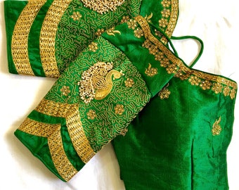 May include: A green silk blouse with gold embroidery and beading. The blouse features a peacock design and a decorative border.