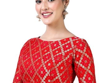 May include: A red brocade blouse with a floral pattern and gold accents. The blouse has a round neckline and short sleeves.