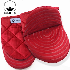 May include: A pair of red quilted oven mitts with a circular pattern on the back. The mitts are made of 100% cotton.